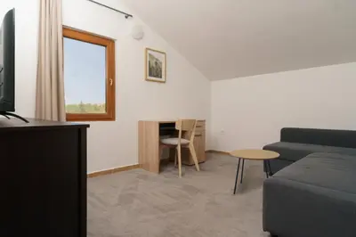 a living room with a couch and a table at MonteHygge apartments in Tivat