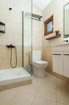 a bathroom with a shower and a toilet and a sink at MonteHygge apartments in Tivat