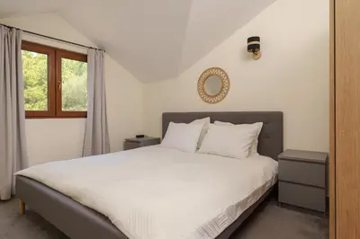 a bedroom with a white bed and a window at MonteHygge apartments in Tivat