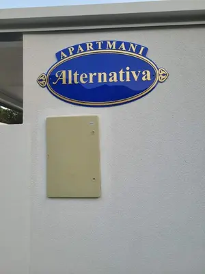 a sign on a wall that reads istg istg at istg af istg istg at Apartmani Alternativa in Biserna Obala