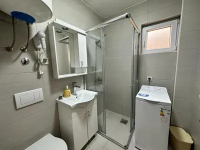 a bathroom with a shower and a toilet and a sink at Студия в Добра Вода in Dobra Voda