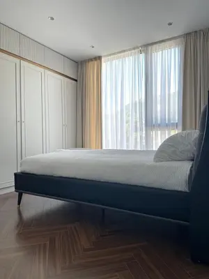 a bedroom with a bed and a large window at Nika in Tivat