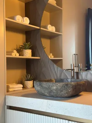 a bathroom with a large stone sink on a counter at Nika in Tivat