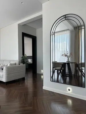 a living room with a table and a mirror at Nika in Tivat