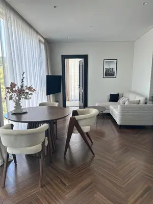a living room with a table and chairs and a couch at Nika in Tivat