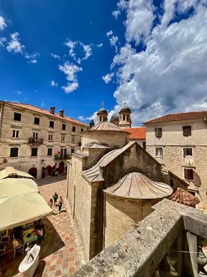 a view of a building with a boat in a courtyard at Private room Shared bathroom and kitchen in Kotor