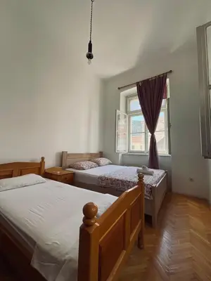 a bedroom with two beds and a window at Private room Shared bathroom and kitchen in Kotor