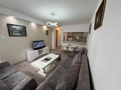 a living room with a couch and a table at Stan na dan BUDVA in Budva