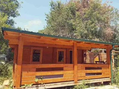 a log cabin with a green roof at Sweet one bedroom cottage Ada Bojana - Ulcinj in Ulcinj
