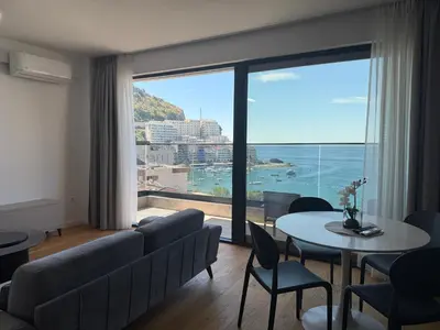 a living room with a couch and a table at Lux Apartman Rafailovici in Rafailovici