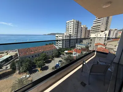 a balcony with a view of the ocean and buildings at Lux Apartman Rafailovici in Rafailovici