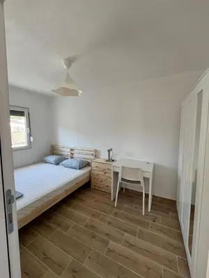a bedroom with a bed and a desk and a table at Deskos sea house in Sutomore I floor in Sutomore