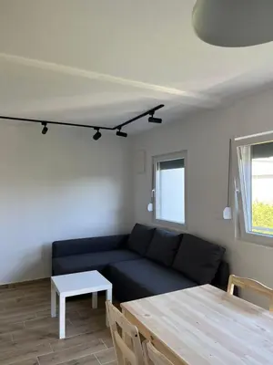 a living room with a blue couch and a table at Deskos sea house in Sutomore I floor in Sutomore