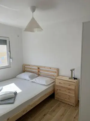 a bedroom with a bed and a lamp and a dresser at Deskos sea house in Sutomore I floor in Sutomore