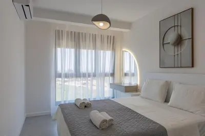 a bedroom with a large bed with towels on it at Casa del Sol Bar in Bar, Susanj
