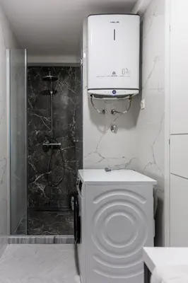 a white bathroom with a toilet and a shower at Casa del Sol Bar in Bar, Susanj
