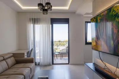 a living room with a couch and a flat screen tv at Casa del Sol Bar in Bar, Susanj