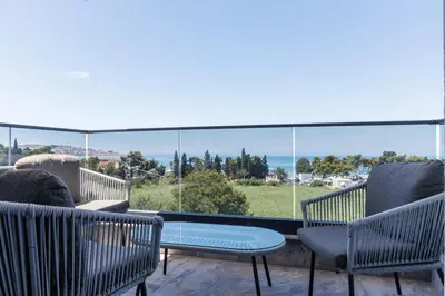 two chairs and a table on a balcony with a view at Casa del Sol Bar in Bar, Susanj
