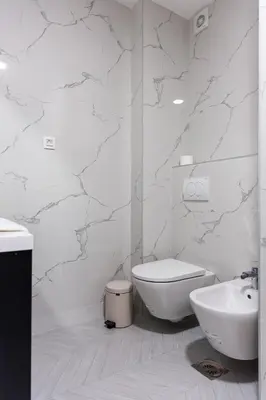 a white bathroom with a toilet and a sink at Casa del Sol Bar in Bar, Susanj