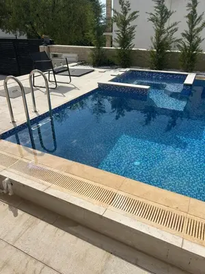a large swimming pool with blue water at Villa Richard in Sutomore