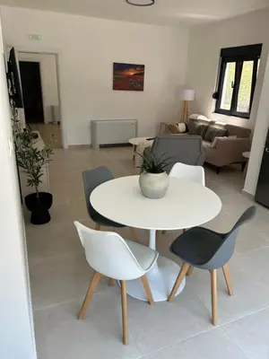 a living room with a white table and chairs at Villa Richard in Sutomore