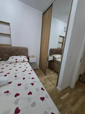 a bedroom with a bed with red hearts on it at Lux Apartment Dani in Bar