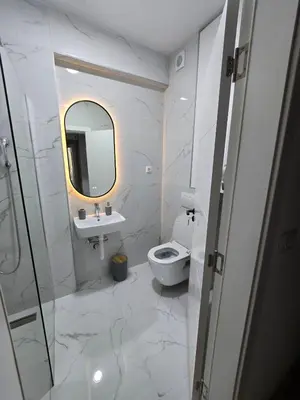 a bathroom with a toilet and a sink and a mirror at Lux Apartment Dani in Bar