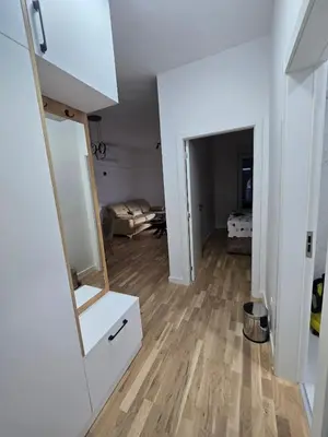 a living room with a mirror and a white cabinet at Lux Apartment Dani in Bar