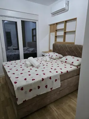 a bedroom with a bed with hearts on it at Lux Apartment Dani in Bar