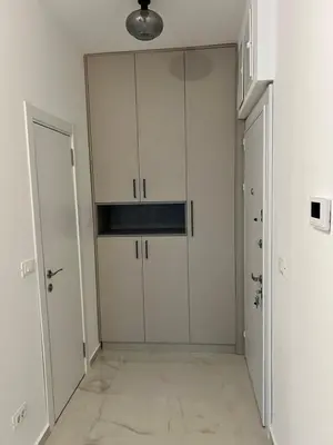 an empty room with white cabinets and a hallway at Apartment L&L in Bar
