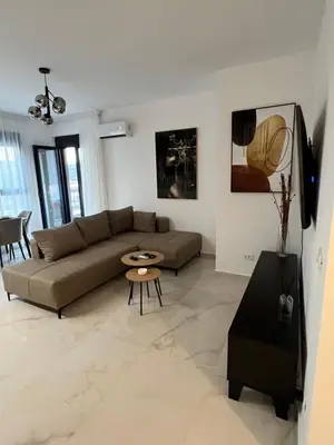 a living room with a couch and a table at Apartment L&L in Bar