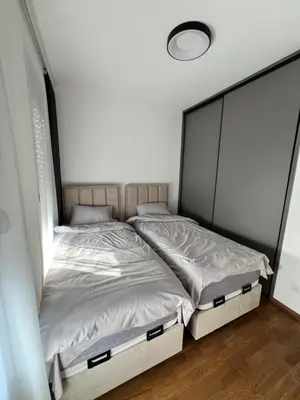 a bed in a room with two twin beds at Apartment L&L in Bar