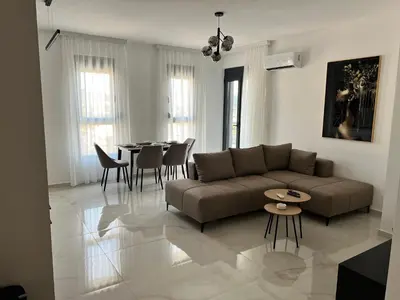 a living room with a couch and a table at Apartment L&L in Bar