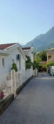 a street with a white house and a fence at Sweet home in Sutomore