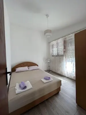 a bedroom with a bed with two towels on it at Sweet home in Sutomore