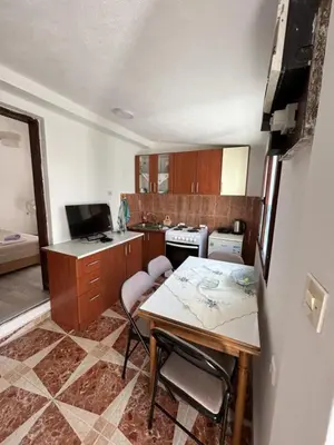 a small kitchen with a table and chairs in it at Sweet home in Sutomore