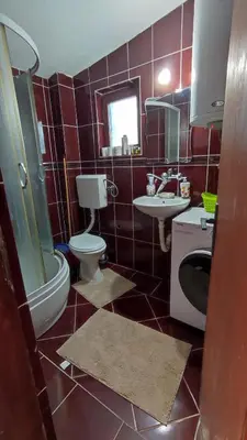 a bathroom with a toilet and a sink and a mirror at Sweet home in Sutomore