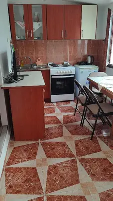 a kitchen with a counter and a stove and a table at Sweet home in Sutomore