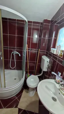 a bathroom with a toilet and a shower and a sink at Sweet home in Sutomore