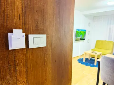 a room with a door with a chair and a table at TaNa's Apartments in Donji Štoj