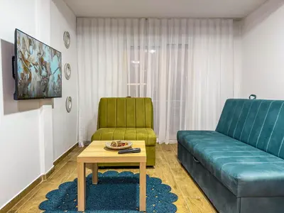 a living room with a couch and a table at TaNa's Apartments in Donji Štoj