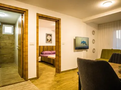 a hotel room with a bed and a mirror at TaNa's Apartments in Donji Štoj