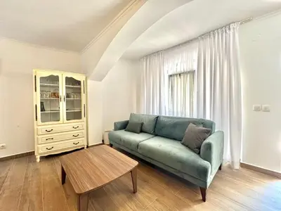 a living room with a couch and a table at Beachfront Holiday Home Rafailovici in Becici