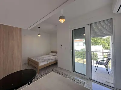 a room with a bed and a table and a window at GIS Villa in Donji Štoj