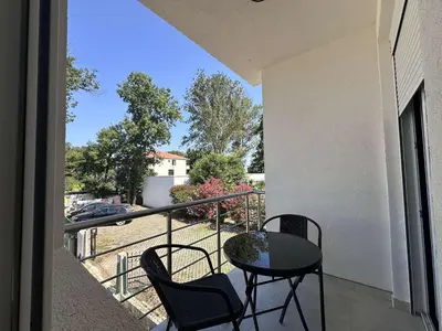 a balcony with a table and chairs on a balcony at GIS Villa in Donji Štoj