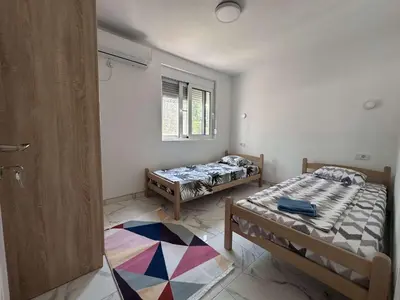 a room with two beds and a window at GIS Villa in Donji Štoj