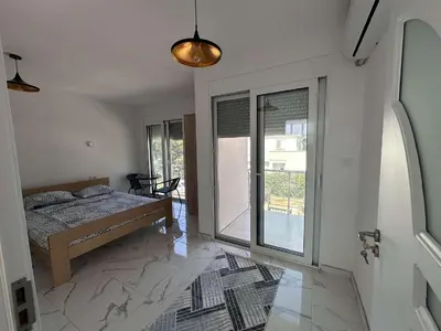 a bedroom with a bed and a large window at GIS Villa in Donji Štoj