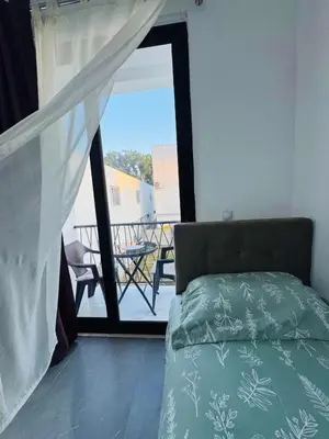 a bedroom with a bed and a view of a balcony at Ulcinj Go in Ulcinj