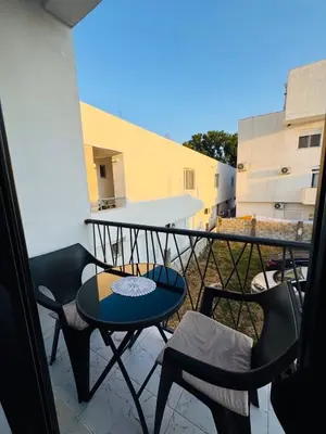 a balcony with a table and chairs on it at Ulcinj Go in Ulcinj
