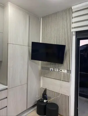 a living room with a flat screen tv on a wall at Nata 25 in Becici